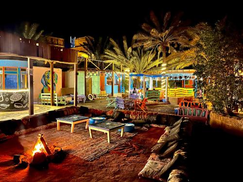 a living room with a fire pit and a playground at Bishbishi Camp Dahab in Dahab