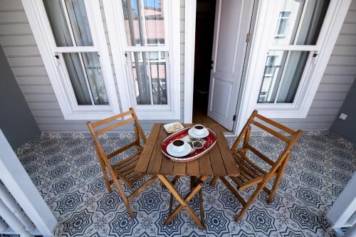 a table with two chairs and a plate of food at İkiz Konak Boutique Hotel in Istanbul