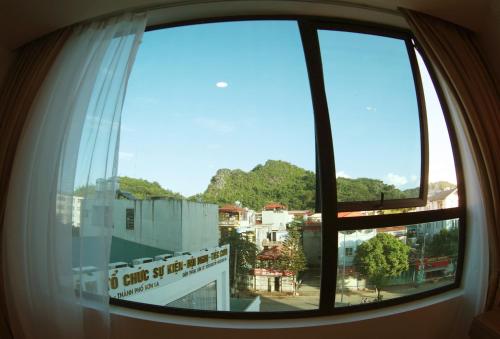 a view of a city from a window at Khách Sạn Hoa Ban Trắng in Sơn La
