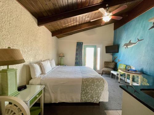 セント・オーガスティンにあるMagic Beach Motel - Vilano Beach, Saint Augustineのベッドとテレビがあるホテルの部屋