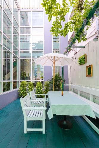a table and chairs on the roof of a building at Pinnacle Lumpinee Park Hotel in Bangkok