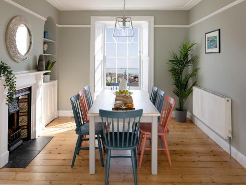 a dining room with a table and chairs at Belmont in Penzance