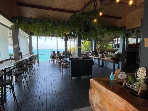a restaurant with a bar with a view of the ocean at Vikasa Yoga Retreat in Lamai