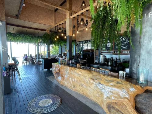 a bar with a wooden counter in a restaurant at Vikasa Yoga Retreat in Lamai