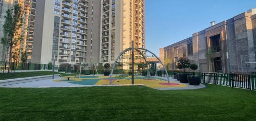 a playground in the middle of a city with tall buildings at Beograd na vodi - BW AURORA LUXURY in Belgrade
