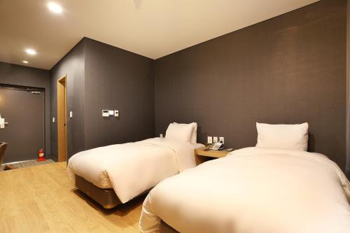 A bed or beds in a room at Bricks Hotel