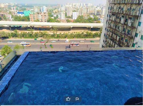 a large swimming pool on the side of a building at Best Western PLUS Maya - Luxury Collection Hotel in Dhaka