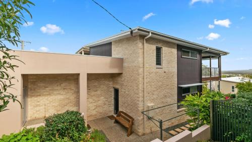 a brick house with a balcony at Saltys Place, Pet Friendly and Close To Beach in Caloundra