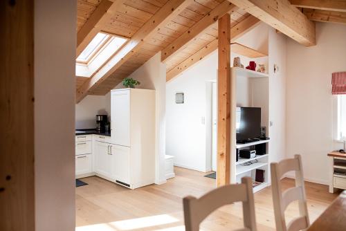 a kitchen with white cabinets and a skylight at Landhaus Constantin Luxus-Appartments in Berchtesgaden