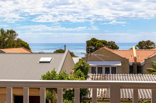 a view of the ocean from the balcony of a house at Abby's Place in Dunsborough