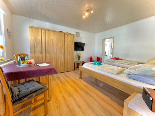 a large room with two beds and a table at Schlafen wie Zuhause Monteur und Ferienwohnungen Rahden in Rahden