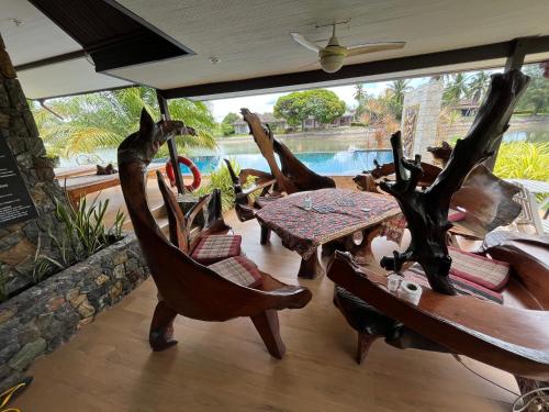 a room with a table and chairs and a pool at Rock Garden E28 Pool villa in Mae Pim