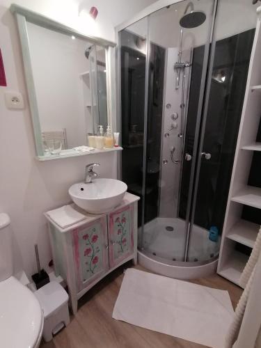 a white bathroom with a sink and a shower at Charmant logis au coeur de Mirepoix in Mirepoix