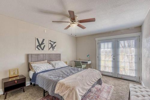 a bedroom with a bed and a ceiling fan at Arlington Duo Two Apts Sleeps 16 Walk to AT&T in Arlington