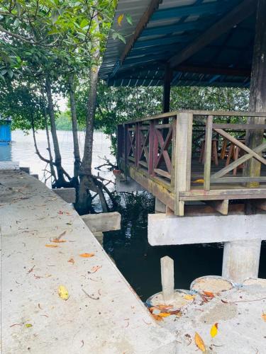 a wooden bridge over a body of water at Homestay Cikgu Sungai Batu Besi in Bedung