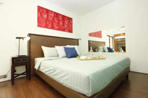 a bedroom with a large bed with a tray on it at UBN by Plush in Kuala Lumpur