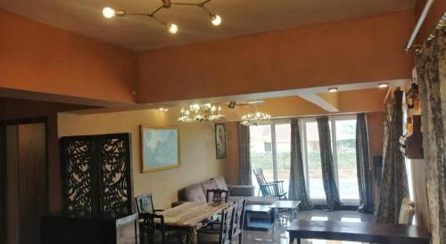 a dining room with a table and chairs and a dining room at West Vally Villa - Casa West in Panchgani