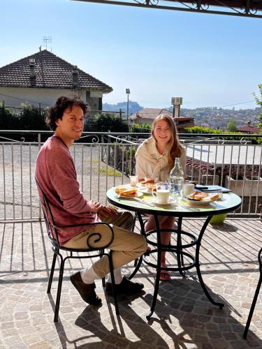 a man and woman sitting at a table with food at Mamaral in Agerola