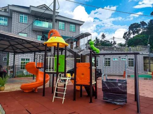 a playground with a slide and a play structure at BerataStay @ Segamat in Segamat