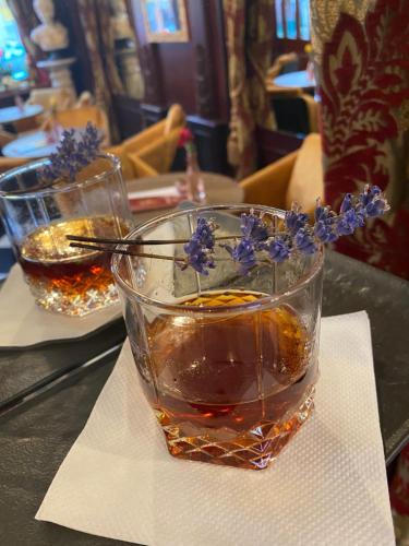 a glass with flowers in it sitting on a table at Penzión Deloris in Trenčín