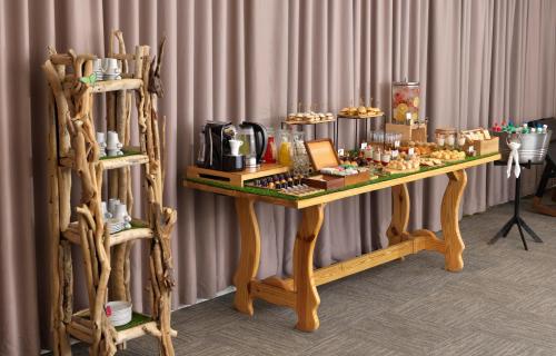 a wooden table with food on it next to a wall at Meliá Punta Cana Beach Wellness Inclusive - Adults only in Punta Cana