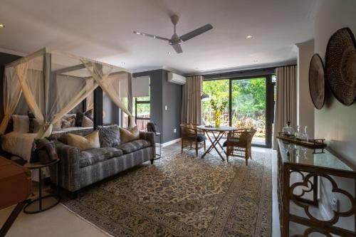 
a living room filled with furniture and a large window at Safari Moon Luxury Bush Lodge in Hoedspruit
