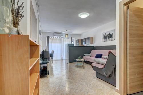 a living room with a couch and a table at Apartments Kajfes in Fažana