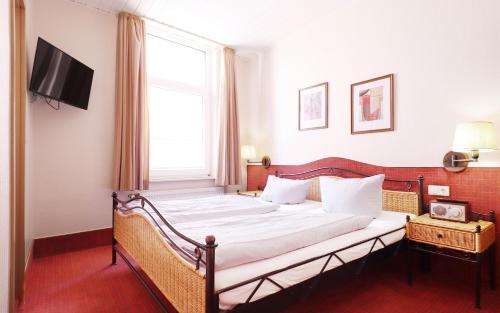 Un pat sau paturi într-o cameră la Kleine Möwe