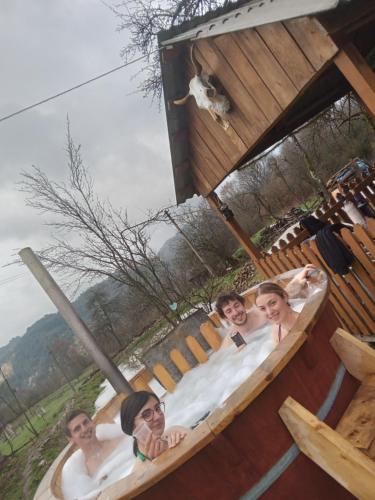 a group of people in a large bath tub at RUSTIC SEJOUR,Roşia Montana in Roşia Montană