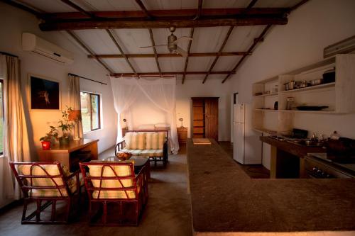 twee foto's van een keuken en een woonkamer bij Kaia Homestead in Sodwana Bay