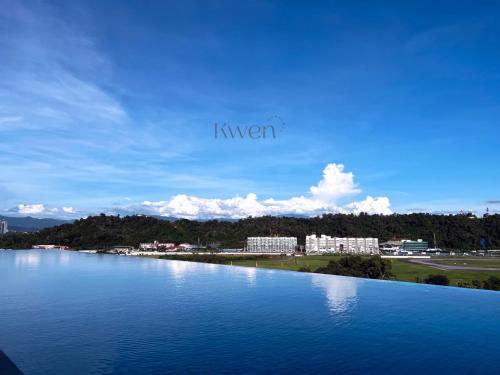 a large body of water with buildings in the background at KWEN Suites-Tanjung Aru InfinityPool Seaview/Airport View in Kota Kinabalu