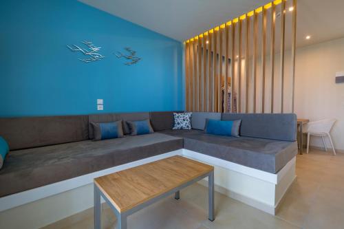 a living room with a couch and a table at Sunny Days in Tigaki