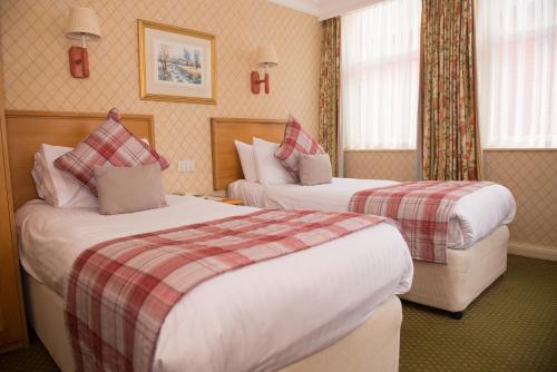 a hotel room with two beds in a room at Crown & Mitre Hotel in Carlisle