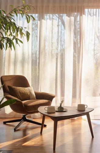 a living room with a chair and a coffee table at Chalets at Blackheath in Blackheath