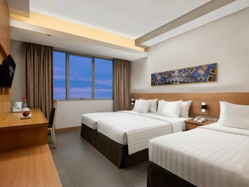 Postel nebo postele na pokoji v ubytování Aston Solo Hotel