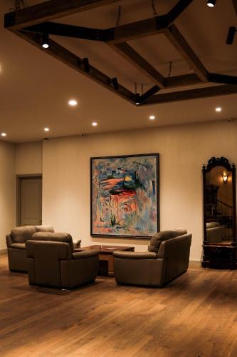 a living room with two couches and a painting on the wall at GRAND HOTEL GYUMRI by APRICOT Hotels in Gyumri