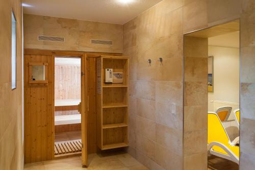 a bathroom with a walk in shower next to a wall at Strandhaus Claassen 06 in Ahrenshoop
