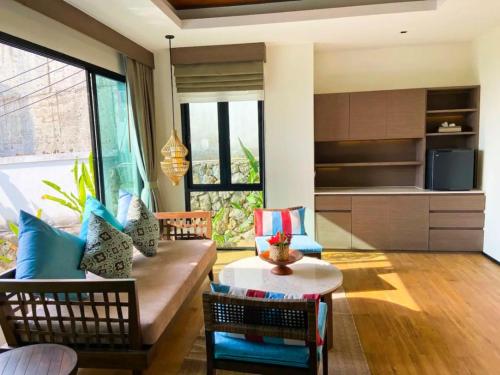 a living room with a couch and a table at Silla Villa Private Pool & Sea View in Kata Beach