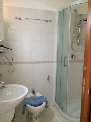 a bathroom with a shower and a toilet and a sink at Agriturismo Eolo in Taranto