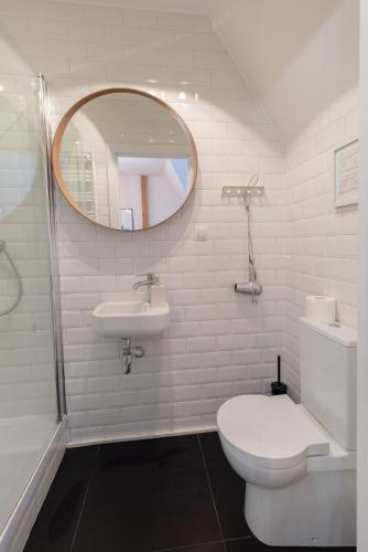 a bathroom with a toilet and a sink and a mirror at Sopot, the very heart! in Sopot