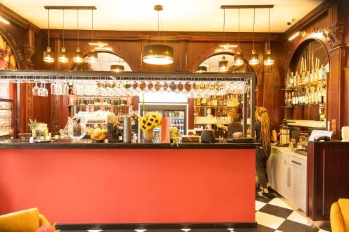 a woman standing behind a bar in a restaurant at Penzión Deloris in Trenčín