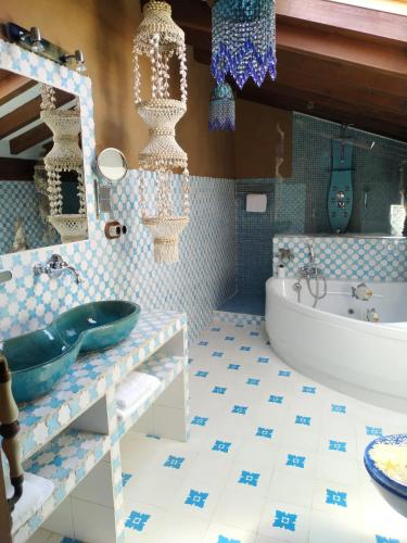 a bathroom with a tub and a sink at Camino a Casa - Suances in Hinojedo