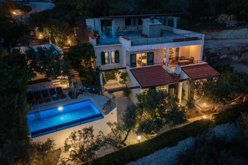 an aerial view of a house with a swimming pool at Holiday Residence Mirabella in Lokva Rogoznica