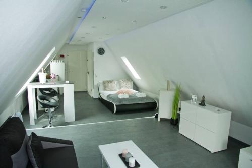Pokój na poddaszu z łóżkiem i biurkiem w obiekcie TRUTH Studio für 3 - Küche - Top Internet - Parkplatz - Modern w Dortmundzie