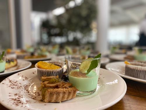 a plate of food with a drink on a table at Hotel Gardenia Fiera in Cermenate