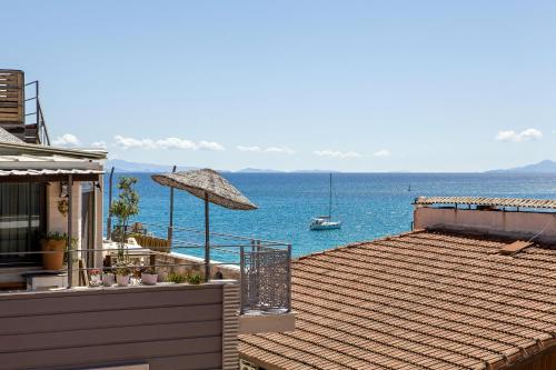 a house with a deck with a view of the ocean at THE LEA HOTELS & SUITE in Didim