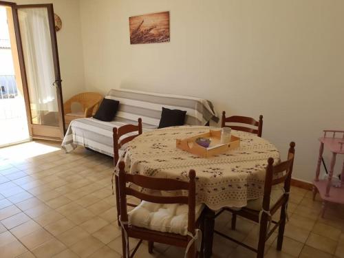 a room with a table and a bed in a room at Résidence Lou Cigaloun - ANA LOCATION in Gréoux-les-Bains