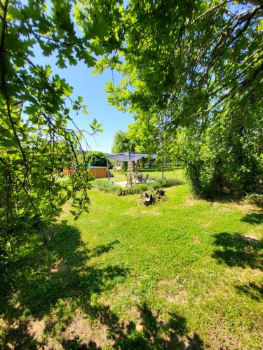 a garden with a gazebo in the distance at The apartment in Saint-Rabier