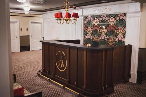 a bar in a room with a floral wall at Arkadia in Radziejów