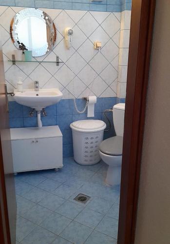 a bathroom with a sink and a toilet and a mirror at Little Paradise in Siviri in Siviri